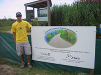 Mark Funk with a Sign Installation on the Long Point Causeway: he assisted in it's constructon  Photo credit: Bernie Solymar